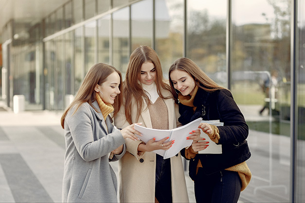 Three young women looking at papers